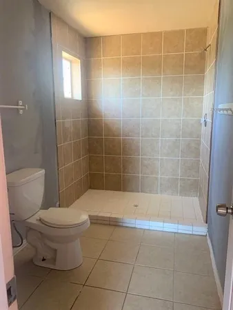 a bathroom with a toilet and a shower