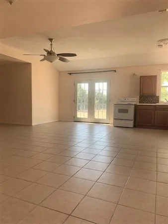 a large white kitchen with a large window