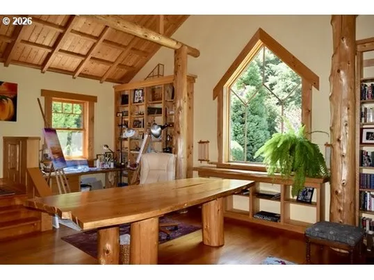 a dining room with wooden floor and a floor to ceiling window