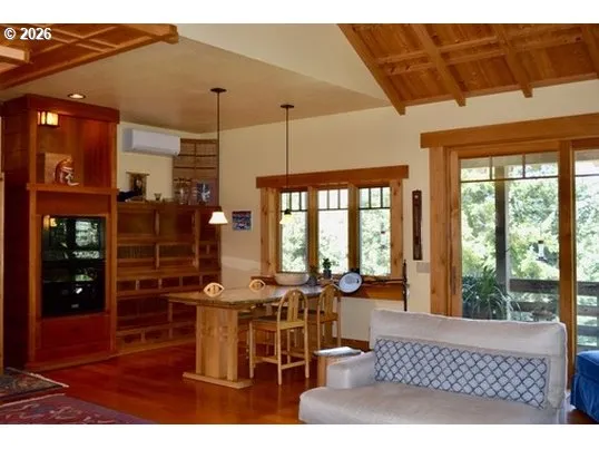 a living room with furniture a flat screen tv and outdoor view