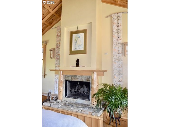 97137 North Bank Rogue River Road Gold Beach, OR 97444 - Photo 23 of 40 a living room with furniture and a fireplace