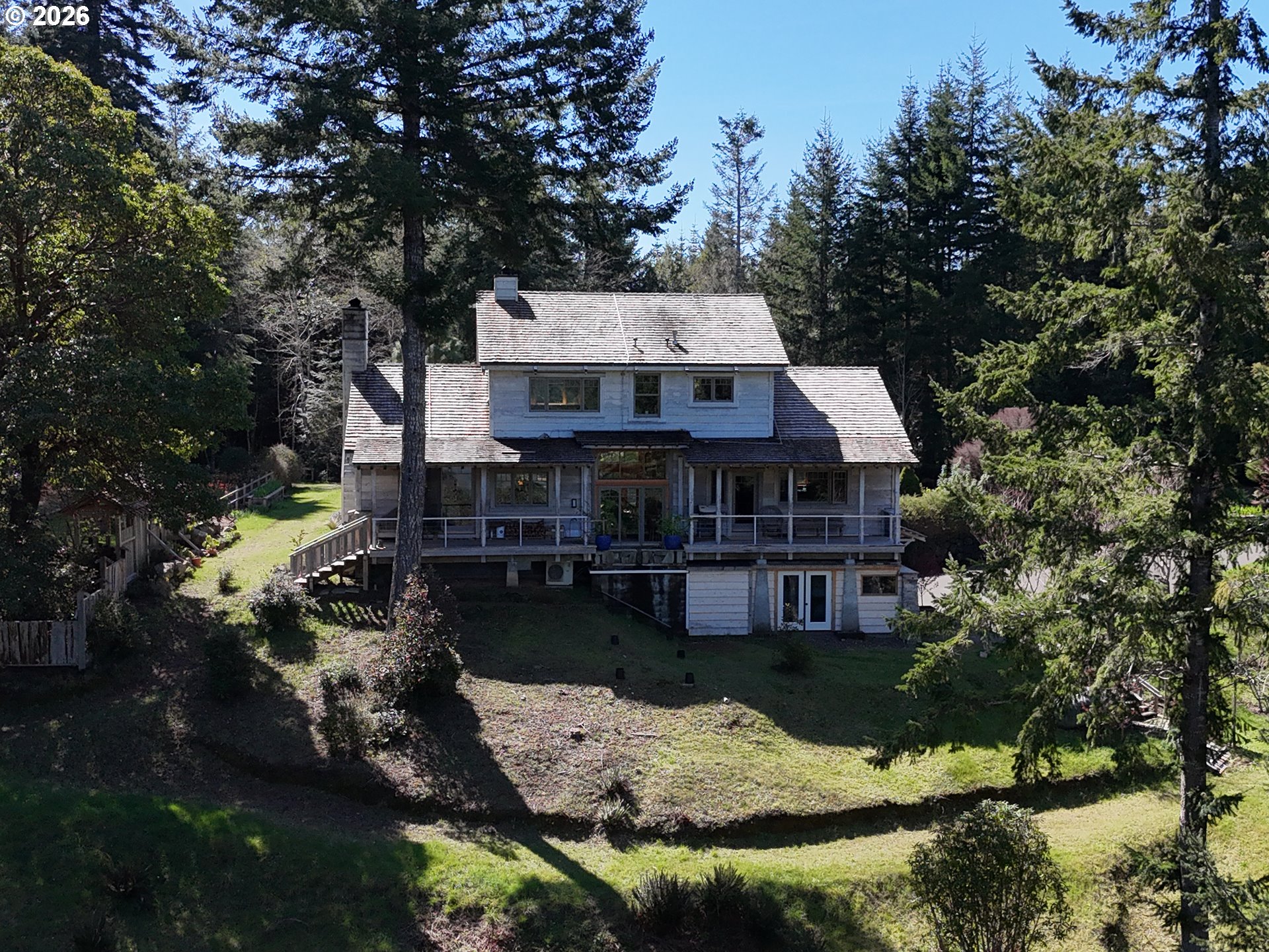 97137 North Bank Rogue River Road Gold Beach, OR 97444 - Photo 3 of 40 a aerial view of a house with swimming pool next to a yard