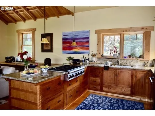 a kitchen with stainless steel appliances granite countertop a sink stove and cabinets