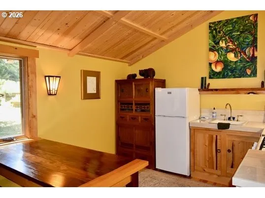 a kitchen with a refrigerator and a stove