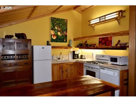 a kitchen with stainless steel appliances granite countertop a stove and a refrigerator