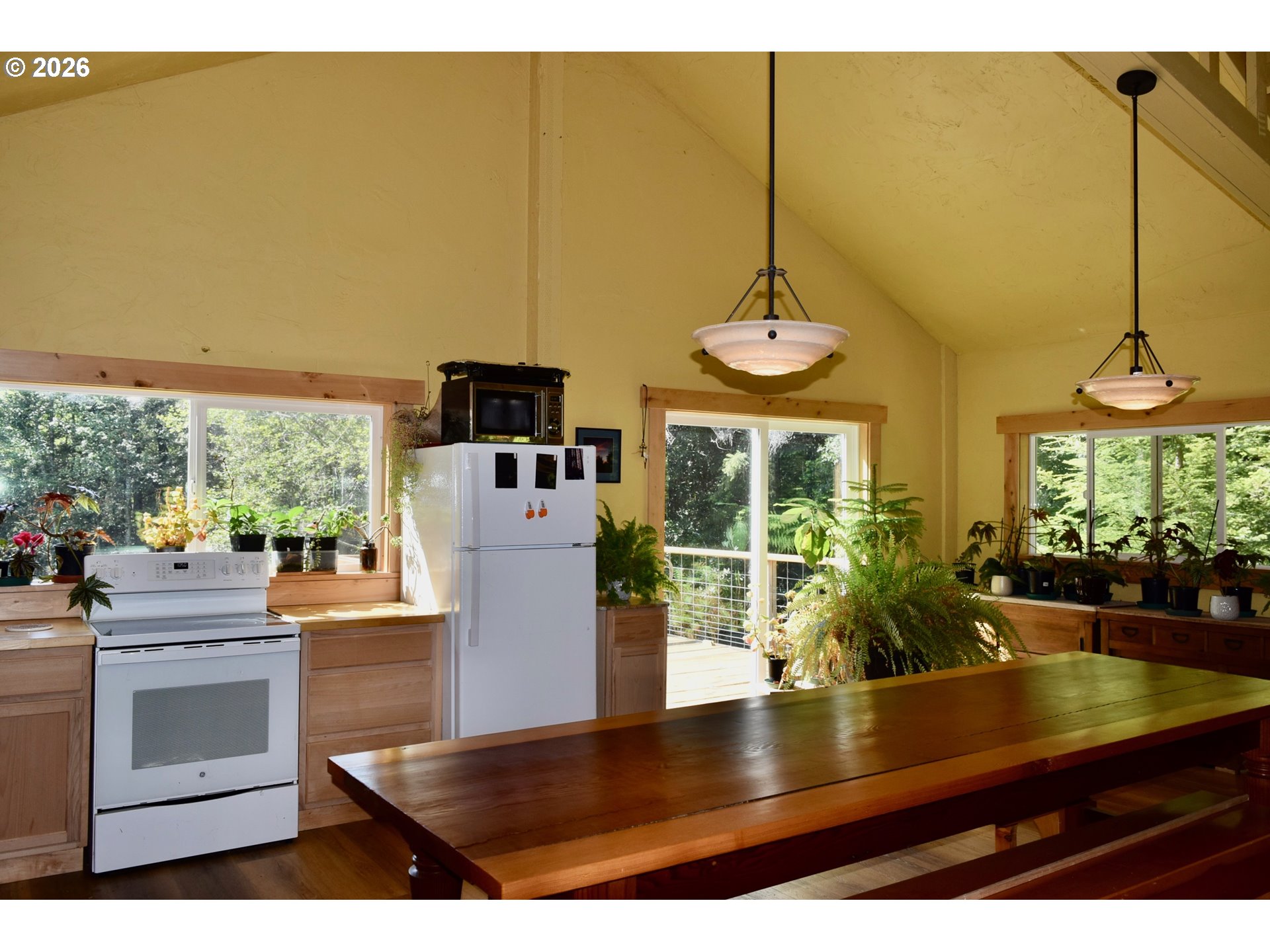 97137 North Bank Rogue River Road Gold Beach, OR 97444 - Photo 42 of 44 a view of a kitchen with kitchen island a counter tops pace a sink and appliances
