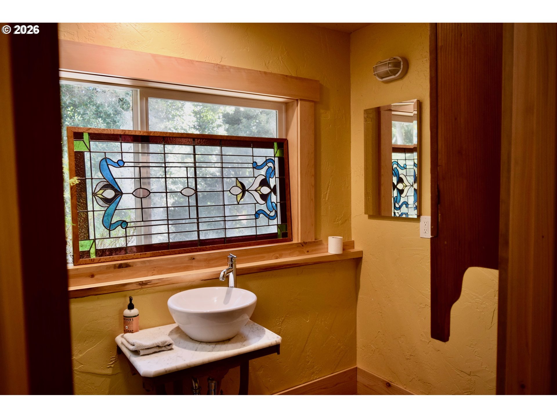 97137 North Bank Rogue River Road Gold Beach, OR 97444 - Photo 44 of 44 a bathroom with a bathtub and a window
