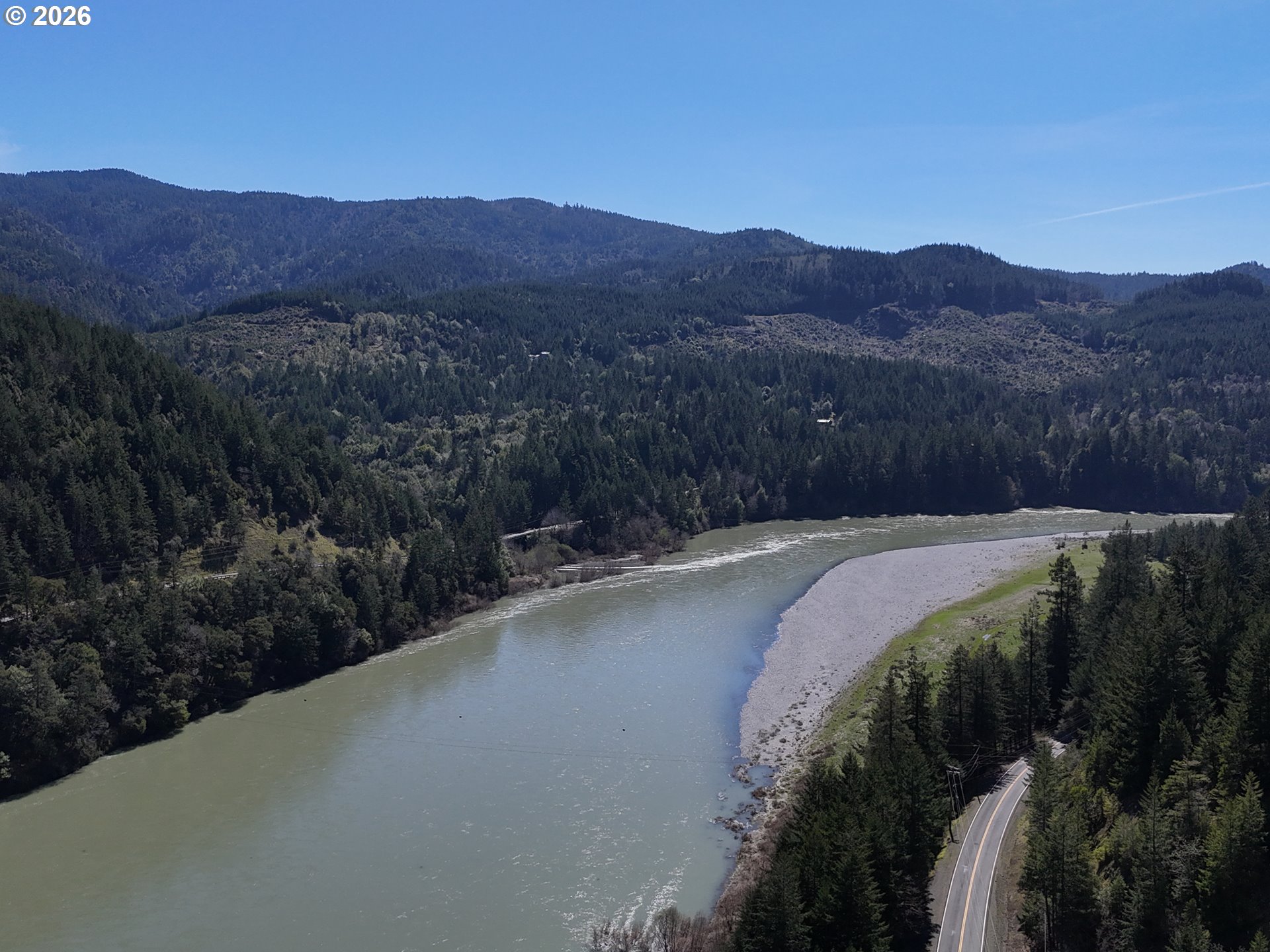 97137 North Bank Rogue River Road Gold Beach, OR 97444 - Photo 7 of 40 a view of a backyard with green space