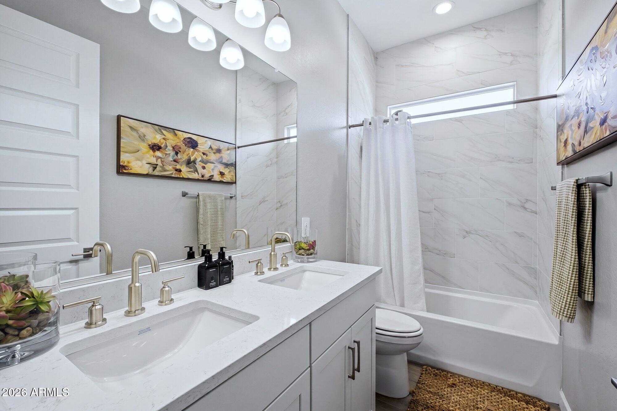 5963 East Lone Cactus Road Phoenix, AZ 85054 - Photo 10 of 22 a bathroom with a sink a toilet and shower