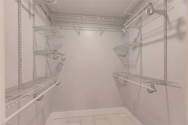 an empty room with wooden floor and a ceiling fan