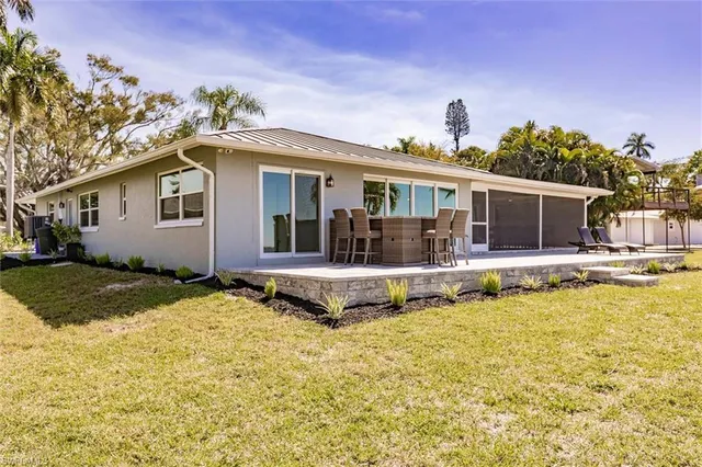 a view of a house with swimming pool and porch