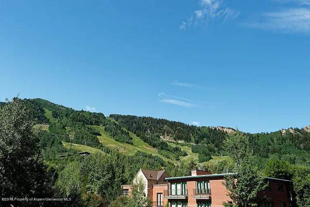 an aerial view of a house with mountain view