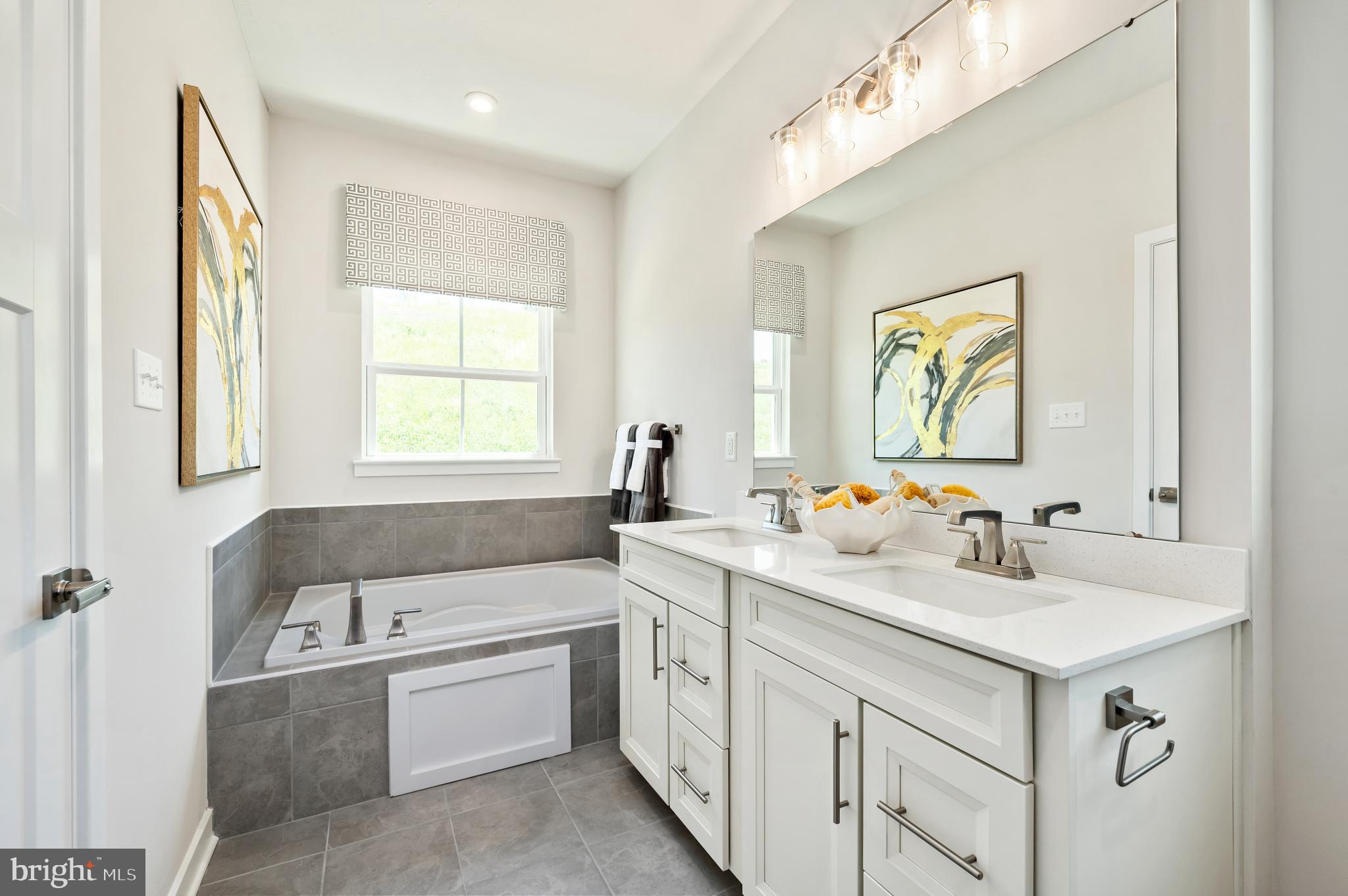 8548 Branch Side Way, Unit B Brandywine, MD 20613 - Photo 13 of 21 a bathroom with a sink vanity tub and a mirror