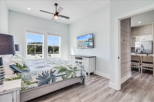 a bedroom with a bed chandelier and a window