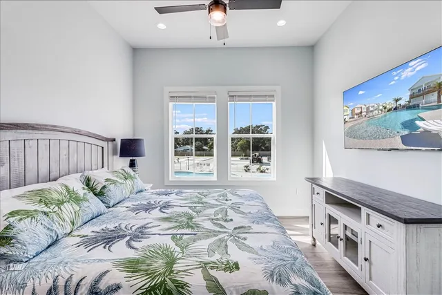 a bedroom with a bed and a large window