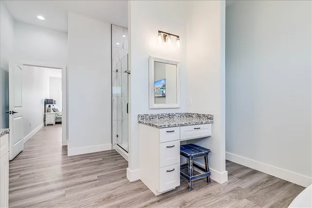 a view of a hallway with wooden floor windows and livingroom