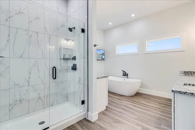 a bathroom with a bathtub a toilet and a shower