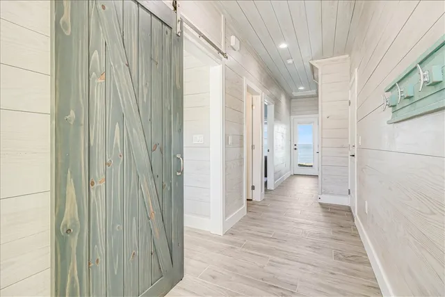 a view of a hallway with wooden floor