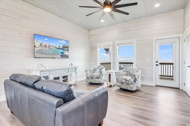 a living room with furniture and wooden floor