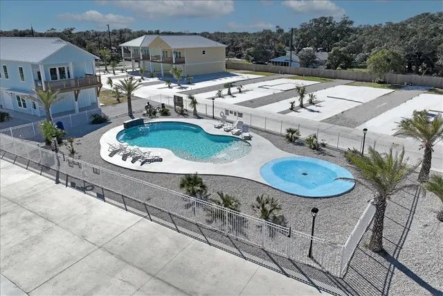 a view of a house with backyard swimming pool and outdoor seating