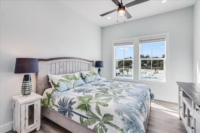 a bedroom with a bed a window and a lamp