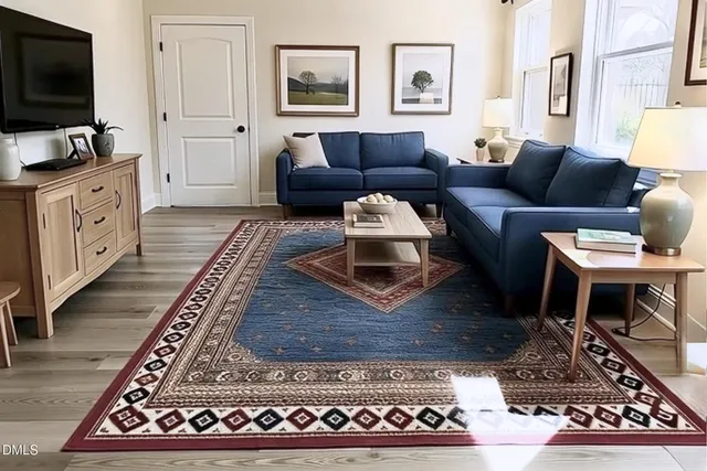 a living room with furniture a rug and a flat screen tv