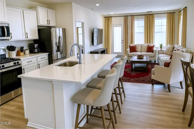a kitchen with a table chairs refrigerator and cabinets
