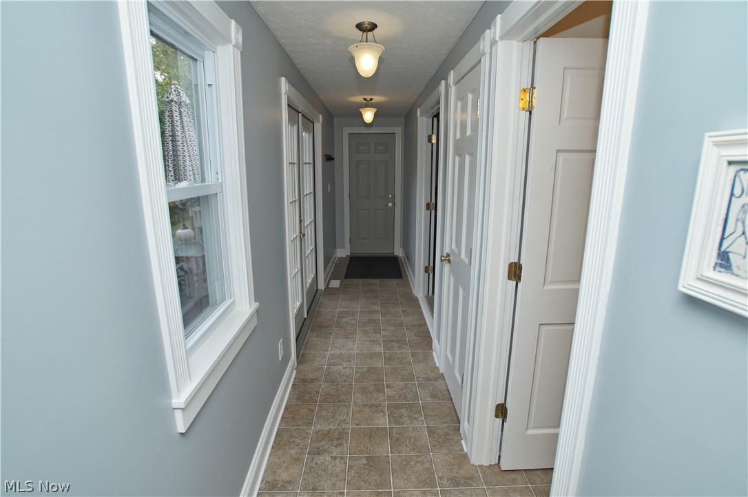 12866 Sperry Road Chesterland, OH 44026 - Photo 13 of 33 Garage door leads to hallway where the first floor bedroom and full bath are connected.