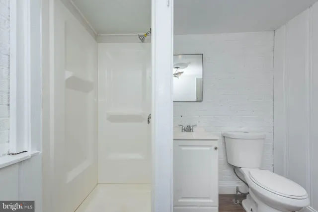 a white toilet sitting next to a bathroom sink