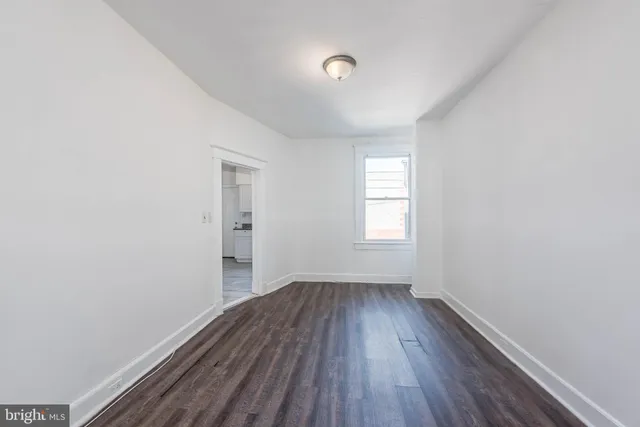 a view of a room with wooden floor and windows
