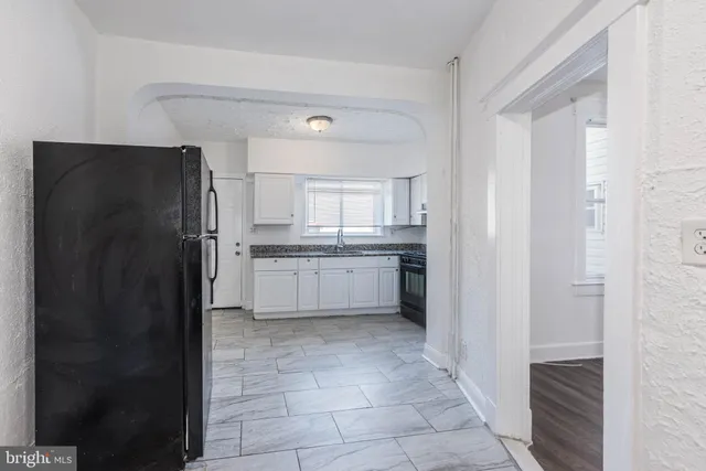 a view of a kitchen with white cabinets