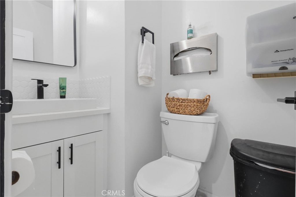 1540 East Wardlow Road Long Beach, CA 90807 - Photo 30 of 38 a white toilet sitting next to a bathroom sink