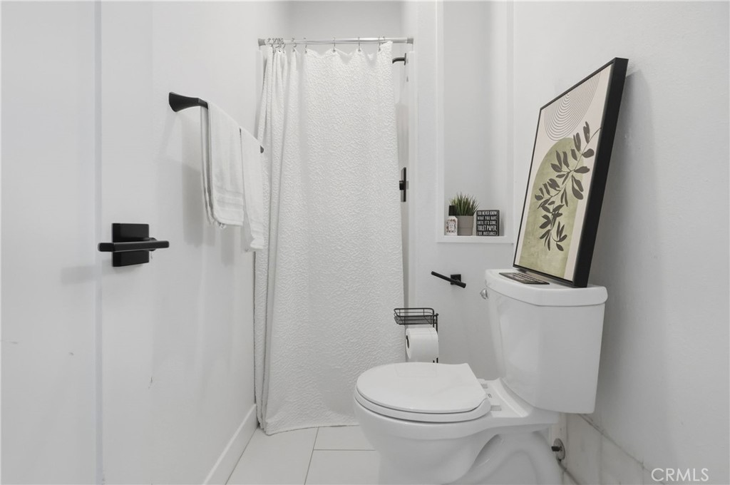 1540 East Wardlow Road Long Beach, CA 90807 - Photo 35 of 38 a bathroom with a toilet and a shower