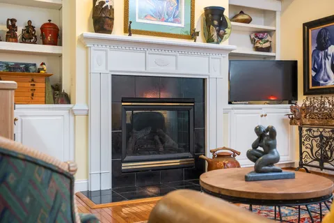 a living room with fireplace furniture and a flat screen tv