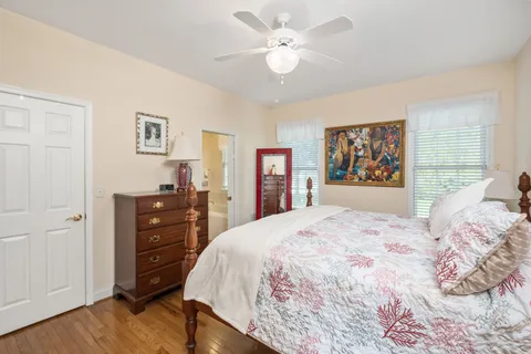 a bedroom with a large bed and a chandelier