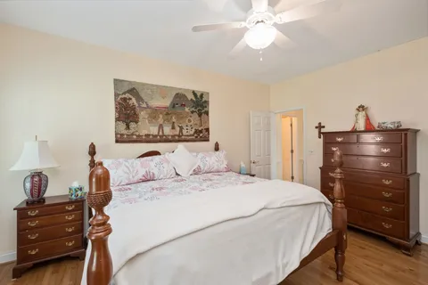 a bedroom with a bed and a chandelier