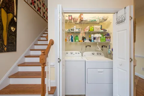 a view of washer and dryer with bathtub in a room