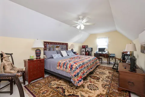 a bedroom with bed and wooden floor