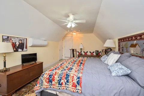a bedroom with bed and a chandelier