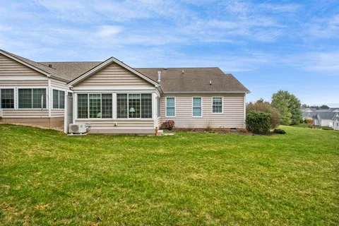 a front view of a house with a garden