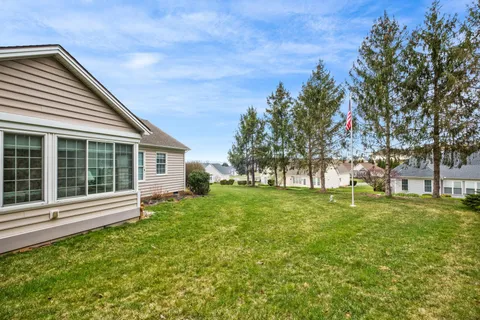 a view of a house with a backyard