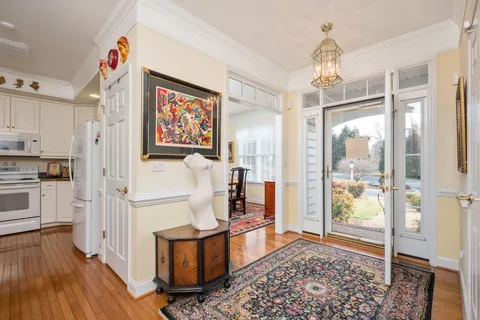a very nice looking room with a large window and wooden floor