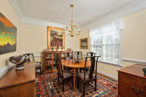 a view of a dining room with furniture and chandelier