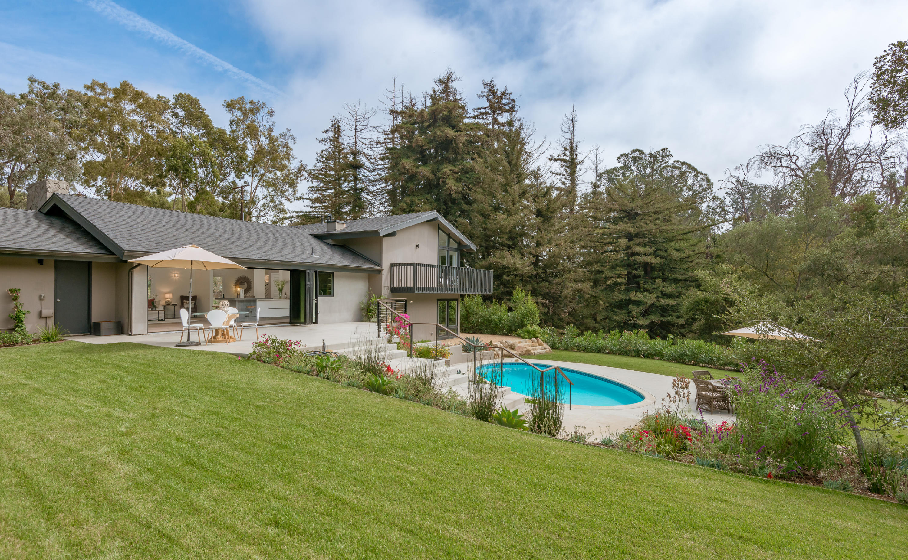 925 El Rancho Road Santa Barbara, CA 93108 - Photo 20 of 20 a front view of house with yard swimming pool and trees in the background