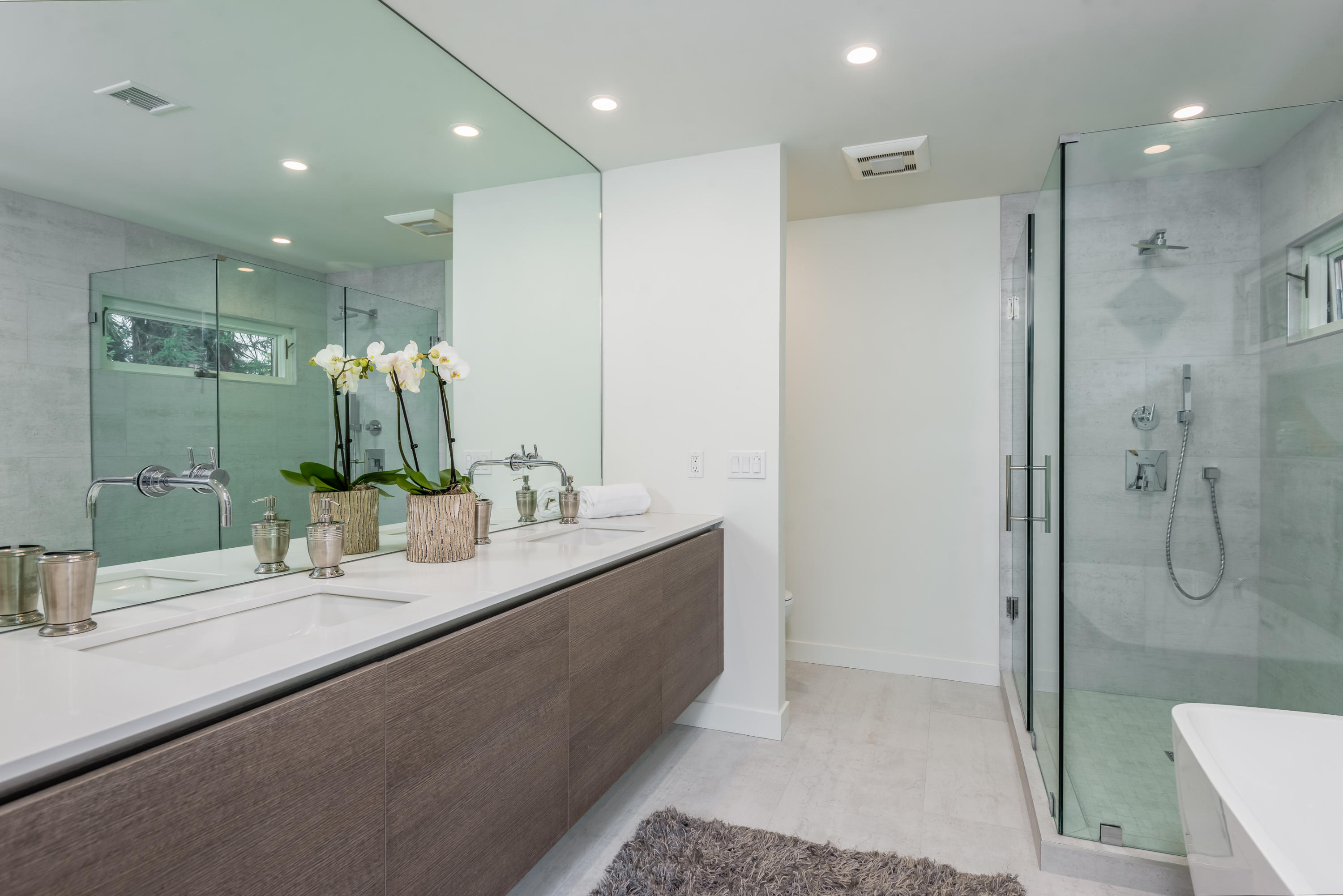 925 El Rancho Road Santa Barbara, CA 93108 - Photo 10 of 20 a bathroom with a double vanity sink and mirror