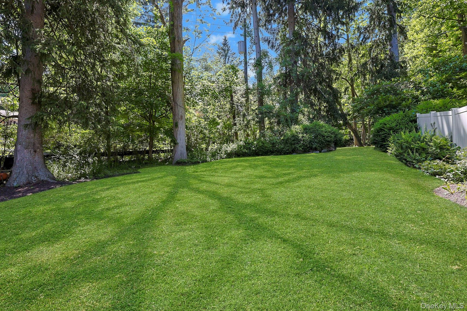 65 Douglas Road Chappaqua, NY 10514 - Photo 38 of 41 With so much outdoor space to enjoy, the yard creates a beautiful setting for gatherings.
