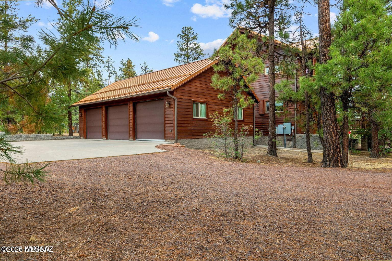 17 2195 Alpine, AZ 85920 - Photo 26 of 48 a backyard of a house with large trees and outdoor seating