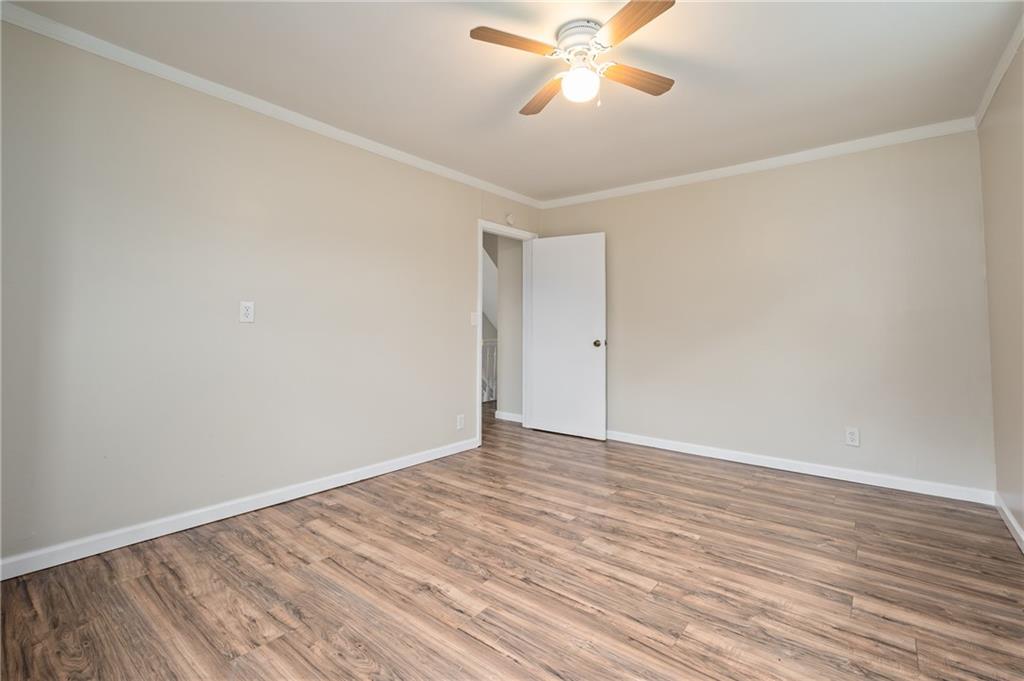 912 2nd Street McKees Rocks, PA 15136 - Photo 14 of 24 a view of an empty room with wooden floor and a ceiling fan