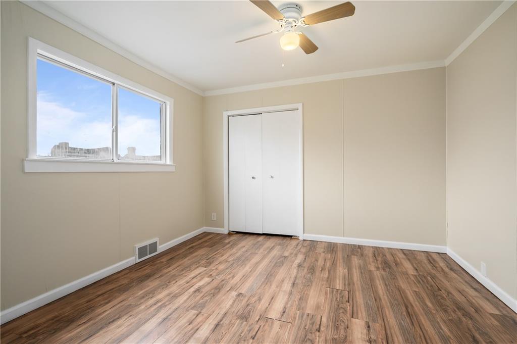 912 2nd Street McKees Rocks, PA 15136 - Photo 15 of 24 a view of an empty room with wooden floor and a window