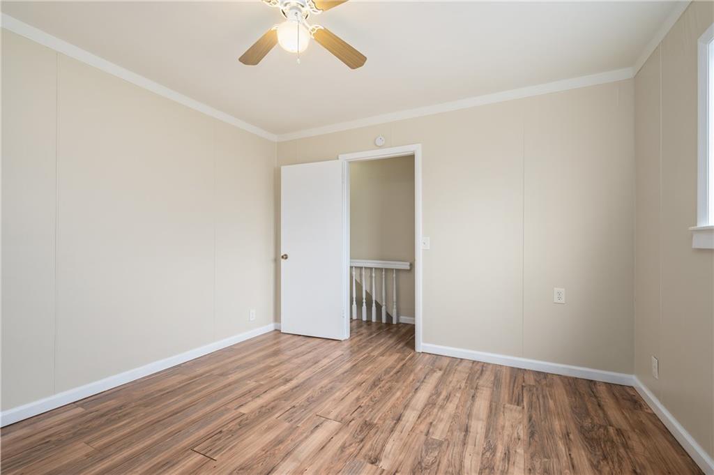 912 2nd Street McKees Rocks, PA 15136 - Photo 17 of 24 an empty room with wooden floor and windows
